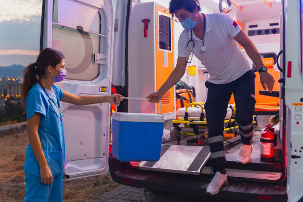 l’équipe médicale pressée portant la boîte de greffes d’organe par ambulance pendant la pandémie - transplantation cardiaque photos et images de collection