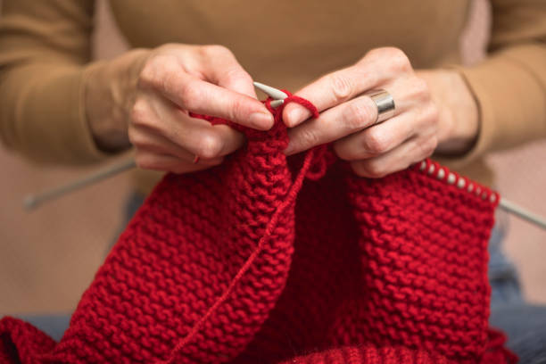 istock girl knits a scarf 1393092116