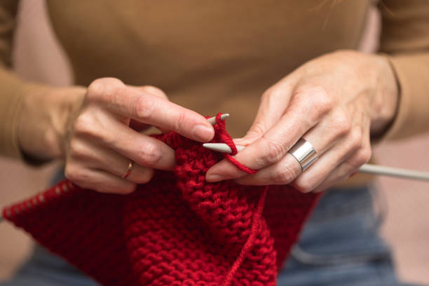 istock girl knits a scarf 1393092175