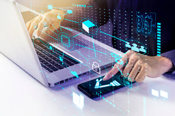 istock A businessman commands a robot via a computer or mobile device.,The electronic business world is the driver of the future. 1393092526