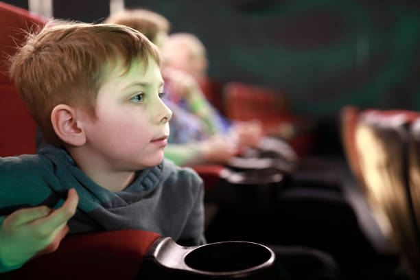 istock Boy watching movie in cinema 1393095055