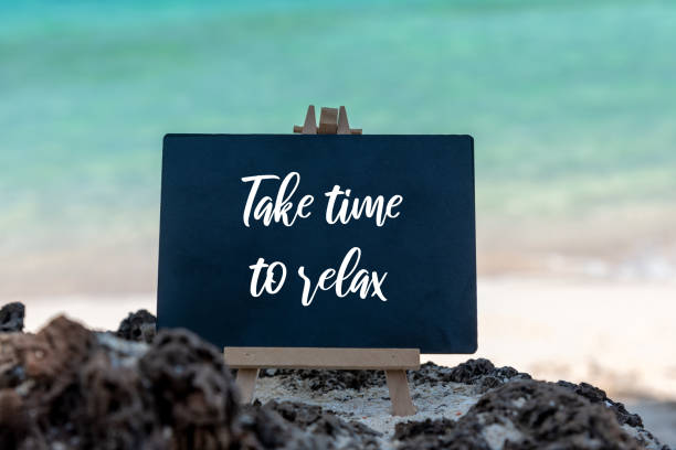 istock Inspirational quotes - Take time to relax beach background 1393095348