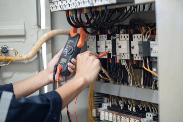 istock Electrician engineer work tester measuring voltage and current of power electric line in electical cabinet control , concept check the operation of the electrical system . 1393098563