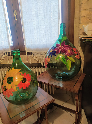 A close-up shot of a collection of recyclable glass bottles standing in a row.