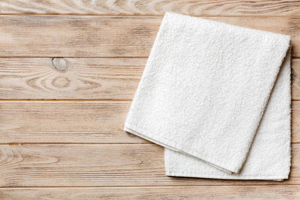 istock Top view of white towels with copy space on colored background 1393098814