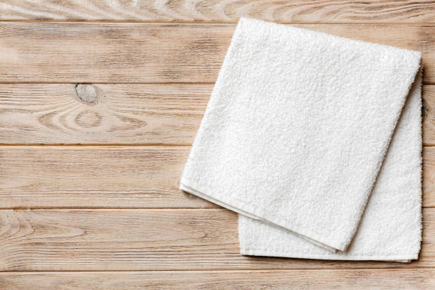 Top view of white towels with copy space on colored background stock photo