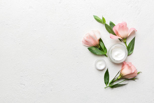 istock Composition with cosmetic products and beautiful roses on cement background. Copy space, flat lay 1393098836