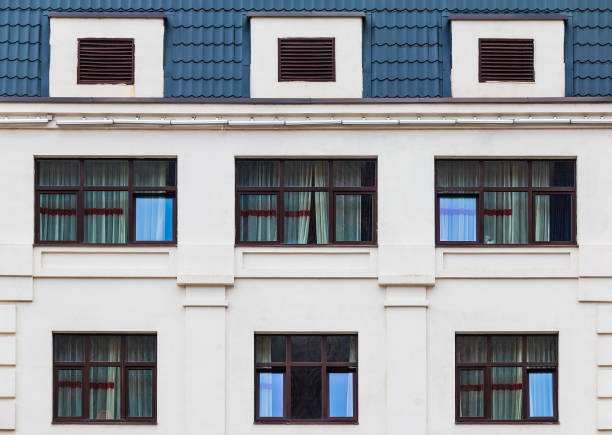 istock Windows in row on facade of urban building 1393101356