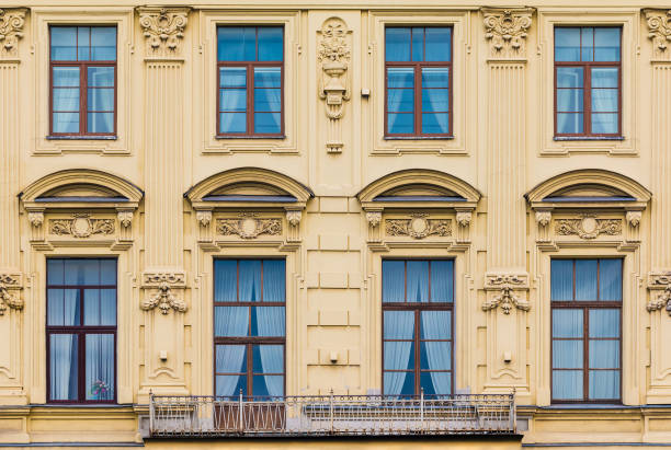 istock Balcony and windows in row on facade of historic building 1393101382