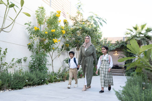istock Middle Eastern mother with young schoolchildren in uniforms 1393101452