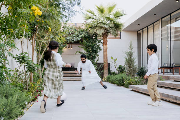 istock Active Middle Eastern family playing soccer on outdoor patio 1393101457