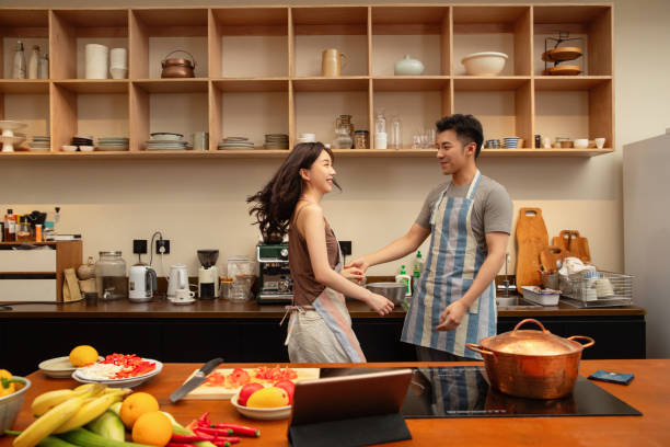 istock Young couples at home cooking and dancing 1393101712