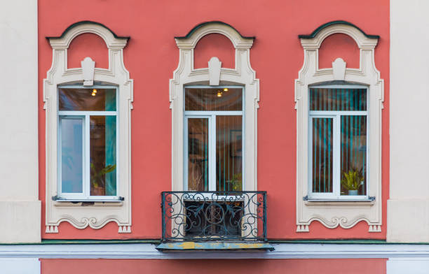 Three windows in a row on the facade of the urban historic apartment building front view, Saint Petersburg, Russia