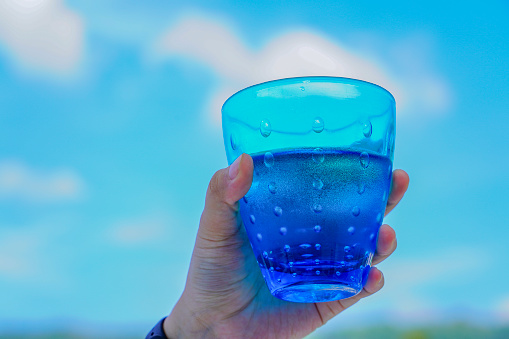 Drinking water, water in cold blue glass.