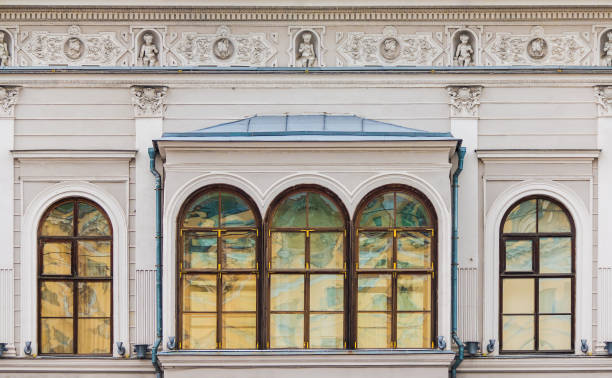 Several windows in a row on the facade of the urban historic apartment building front view, Saint Petersburg, Russia