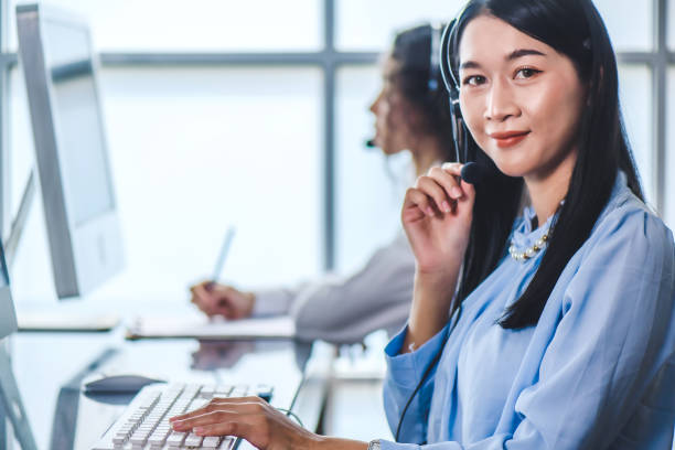 istock Young friendly operator woman agent with headsets 1393104722