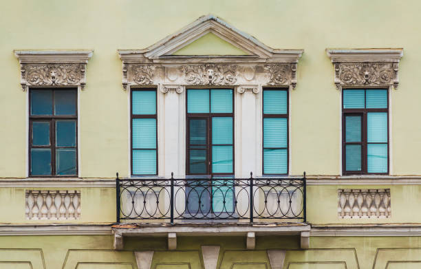 istock Balcony and windows in row on facade of historic building 1393105347