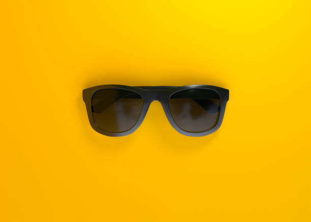 istock Black sunglasses on yellow background 1393108277