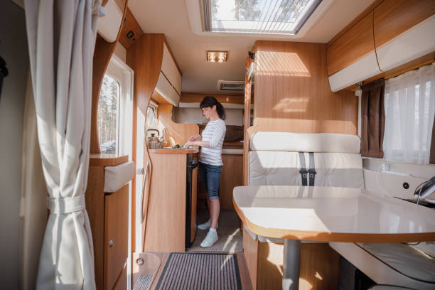 istock Woman cooking in camper, motorhome interior 1393111620