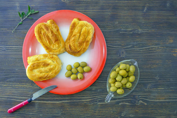istock Balkan cuisine. Bureks ( filled pastry, popular national dish )  and olives on red plate 1393111707