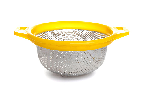 aluminum kitchen colander with plastic yellow handle isolated on white background.