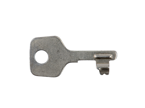Real used small Gray metal key with scratches for little locks, e. g. simple suitcase or mailbox locks. Close up and front view high resolution XXL image, isolated on white, clipping path.