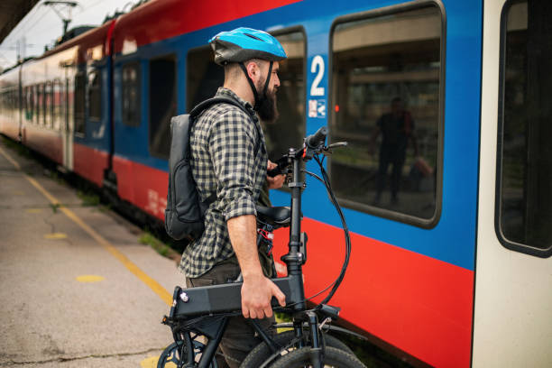 Casually clothed hipster man with folding cycle stock photo