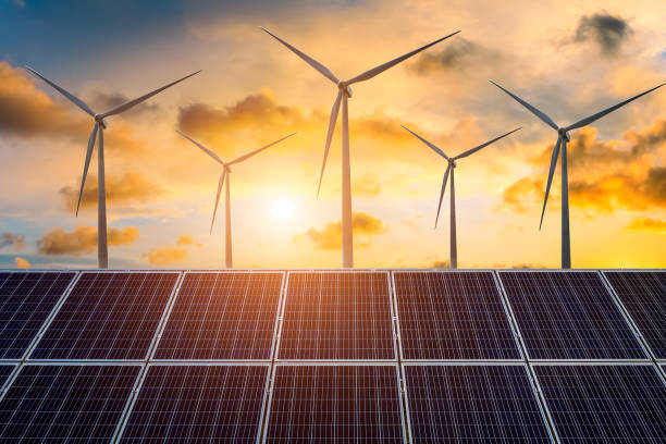 istock Wind turbines and solar panels at sunset 1393121904