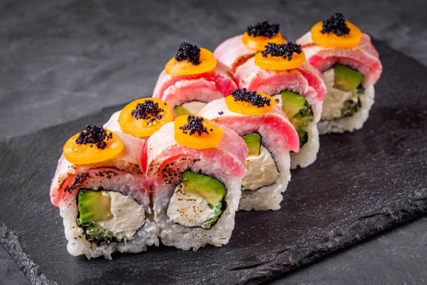 istock delicious sushi rolls on a black stone background 1393124885