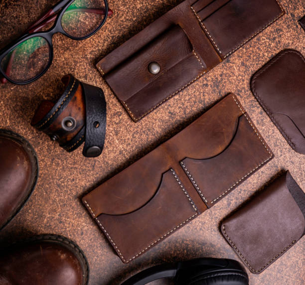 istock Brown leather wallets and cardholders, boots, headphones, flat lay from above with copy space. Businessman accessories stylish clothes 1393126076