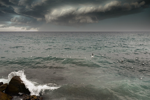 Sanremo, Imperia, Liguria, Italy - 01 04 2022: Dramatic seascape with rough sea and stormy clouds in winter, Italian Riviera.