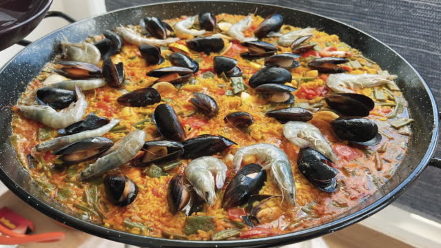 Preparing the real paella with seafood from Valencia