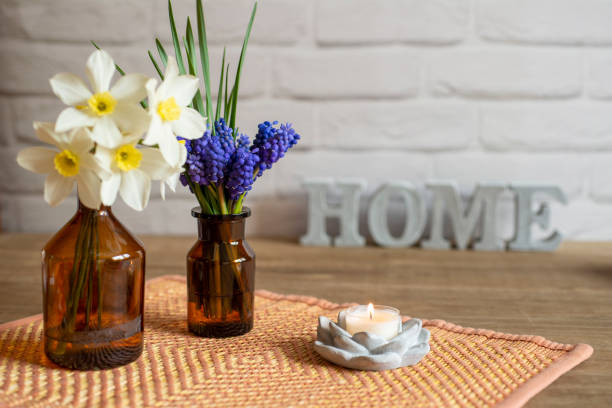 istock Grape Hyacinth bouquet with spring flowers, candle and word Home 1393130793