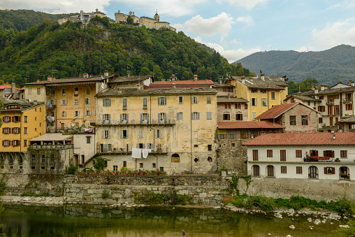Varallo, Italy - 5 September 2021: Varallo Sesia village and Sacred mountain sanctuary on background in Piedmont, Italy