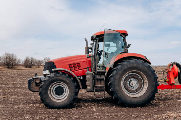 istock Spring sowing season. Farmer with a tractor sows corn seeds on his field. Planting corn with trailed planter. Farming seeding. The concept of agriculture and agricultural machinery. 1393131995