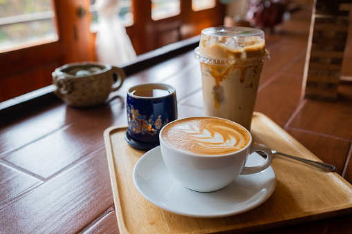 hot latte art coffee on wood table, relax time