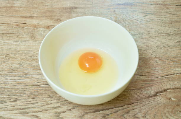 istock raw egg with yolk  in bowl 1393133415