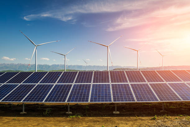 istock Solar panels and wind turbines with mountain landscape 1393136032