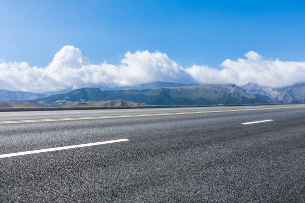 istock Asphalt road and mountain background 1393142662