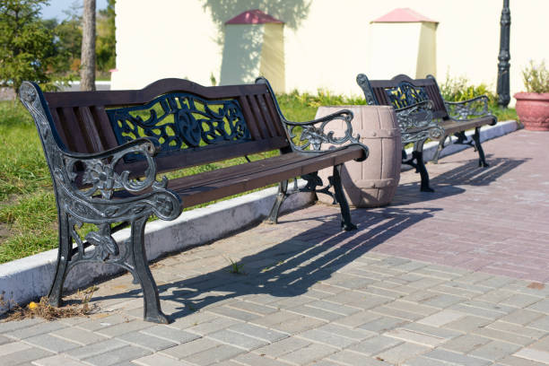 istock Stylish wrought-iron bench in summer park 1393143573