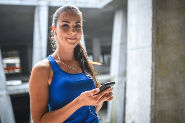 istock Sportswoman texting with her phone during a gym break 1393145746