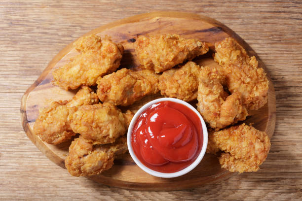 istock fried chicken with ketchup, top view 1393147214