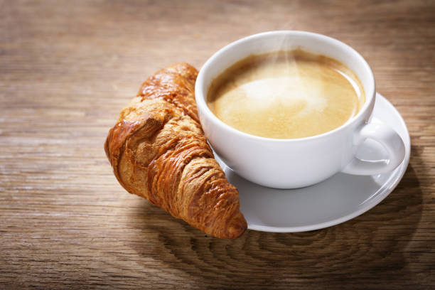 istock cup of coffee with croissant 1393147228