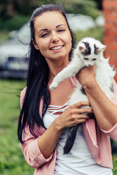 istock Young Smiling Girl Holds her White Cat. 1393149537