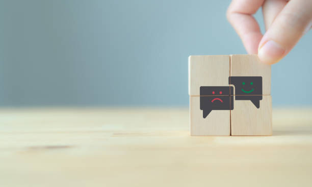 istock Consumer feedback concept.  Customer satisfaction evaluation to improve and develop product and service. Customer centric.  Hand put wooden cubes with 