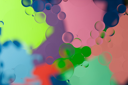 Abstract image of oil bubbles on the water surface with blur vivid and colorful background