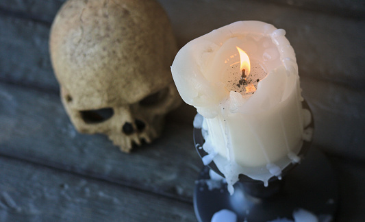 A gothic scene with a burning candle.