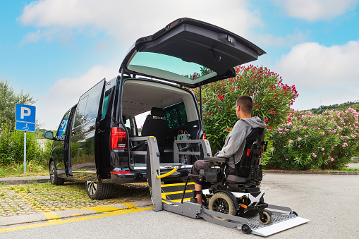Accessible car with wheelchair lift ramp for person with disability