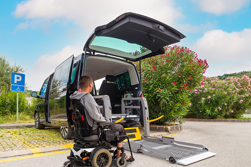 Accessible car with wheelchair lift ramp for person with disability