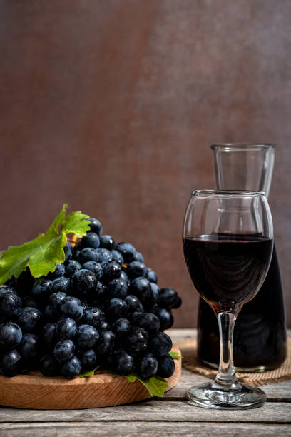istock Red wine and grapes on wooden background 1393152928